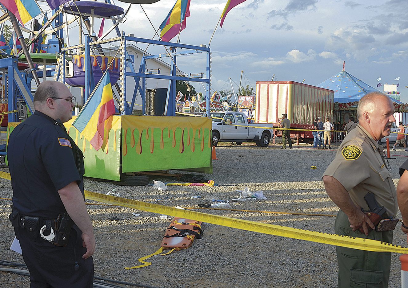 PHOTO: Law enforcement gather around the Ferris wheel Tuesday, Aug. 9, 2016, where debris is visible after an accident at a county fairground Monday night in Greenville, Tenn.