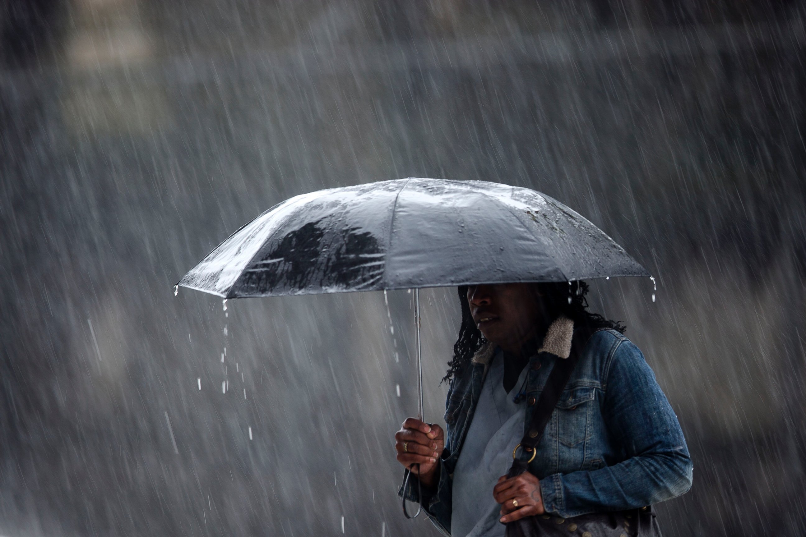 PHOTO: A pedestrian crosses the street in a rainstorm, April 30, 2014, in Philadelphia.