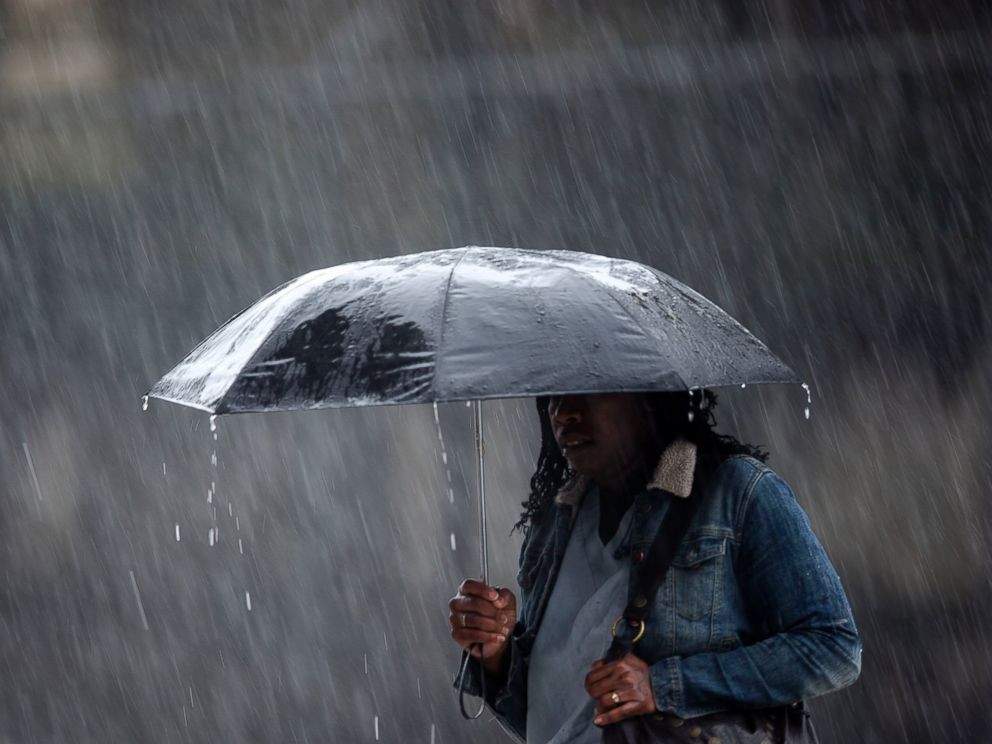 PHOTO: A pedestrian crosses the street in a rainstorm, April 30, 2014, in Philadelphia.