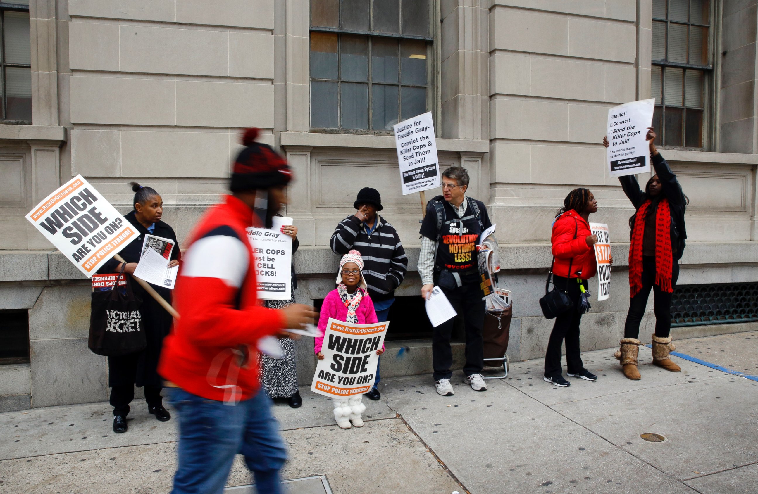 PHOTO: A group of protesters stand outside a courthouse as jury deliberations continue for the trial of Officer William Porter, one of six Baltimore city police officers charged in connection to the death of Freddie Gray, Dec. 16, 2015, in Baltimore. 