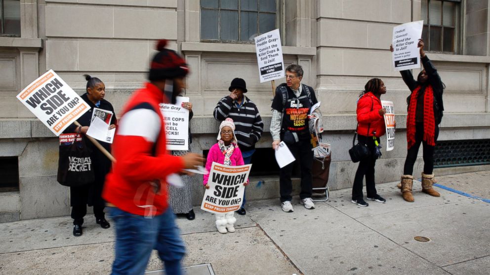 PHOTO: A group of protesters stand outside a courthouse as jury deliberations continue for the trial of Officer William Porter, one of six Baltimore city police officers charged in connection to the death of Freddie Gray, Dec. 16, 2015, in Baltimore. 