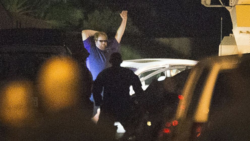 PHOTO: A shooting suspect raises his hands as law enforcement officers surround him following a three-hour standoff, July 9, 2014, in Spring, Texas.