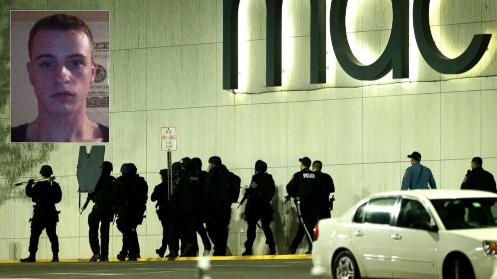 Officials wearing tactical gear walk outside of Garden State Plaza Mall following reports of a shooter, Nov. 4, 2013, in Paramus, N.J. 