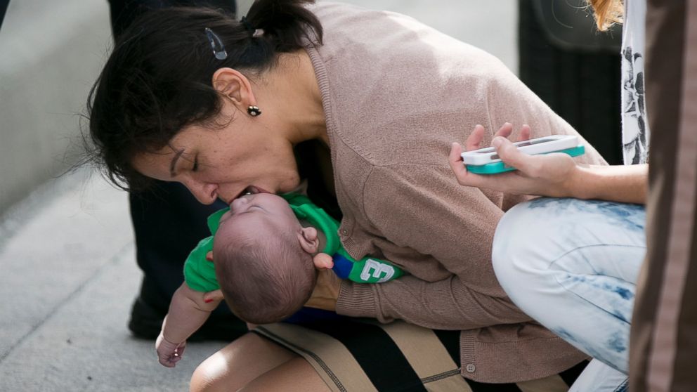 Pamela Rauseo, 37, performs CPR on her nephew, five-month-old Sebastian de la Cruz, after pulling her SUV over on the side of a Florida highway, Feb. 20, 2014.