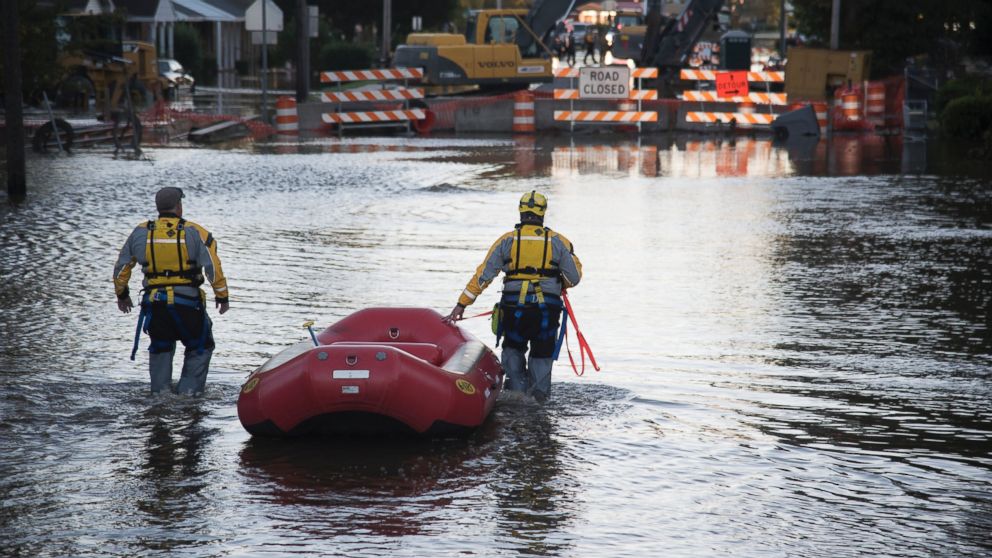 PHOTO: A swift water rescue team down a street covered by floodwaters caused by rain from Hurricane Matthew, on Oct. 10, 2016, in Lumberton, North Carolina. 