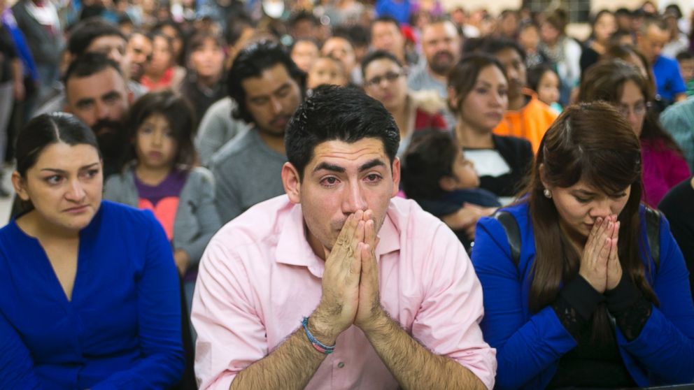Viridiana Carrizales of San Antonio, Texas, Jose Patino, of Phoenix, and his girlfriend Reyna Montoya of Mesa, react during a watch party for President Obama's speech on immigration in Phoenix, Nov. 20, 2014.