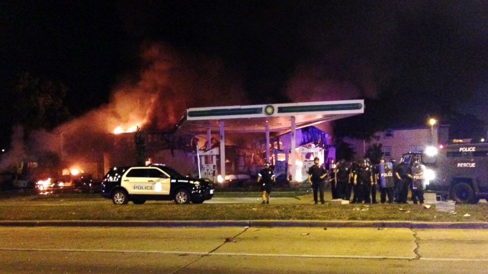 PHOTO: Authorities respond near a burning gas station as dozens of people protest following the fatal shooting of a man in Milwaukee, Saturday, Aug. 13, 2016.