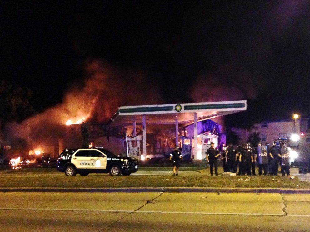 PHOTO: Authorities respond near a burning gas station as dozens of people protest following the fatal shooting of a man in Milwaukee, Saturday, Aug. 13, 2016.