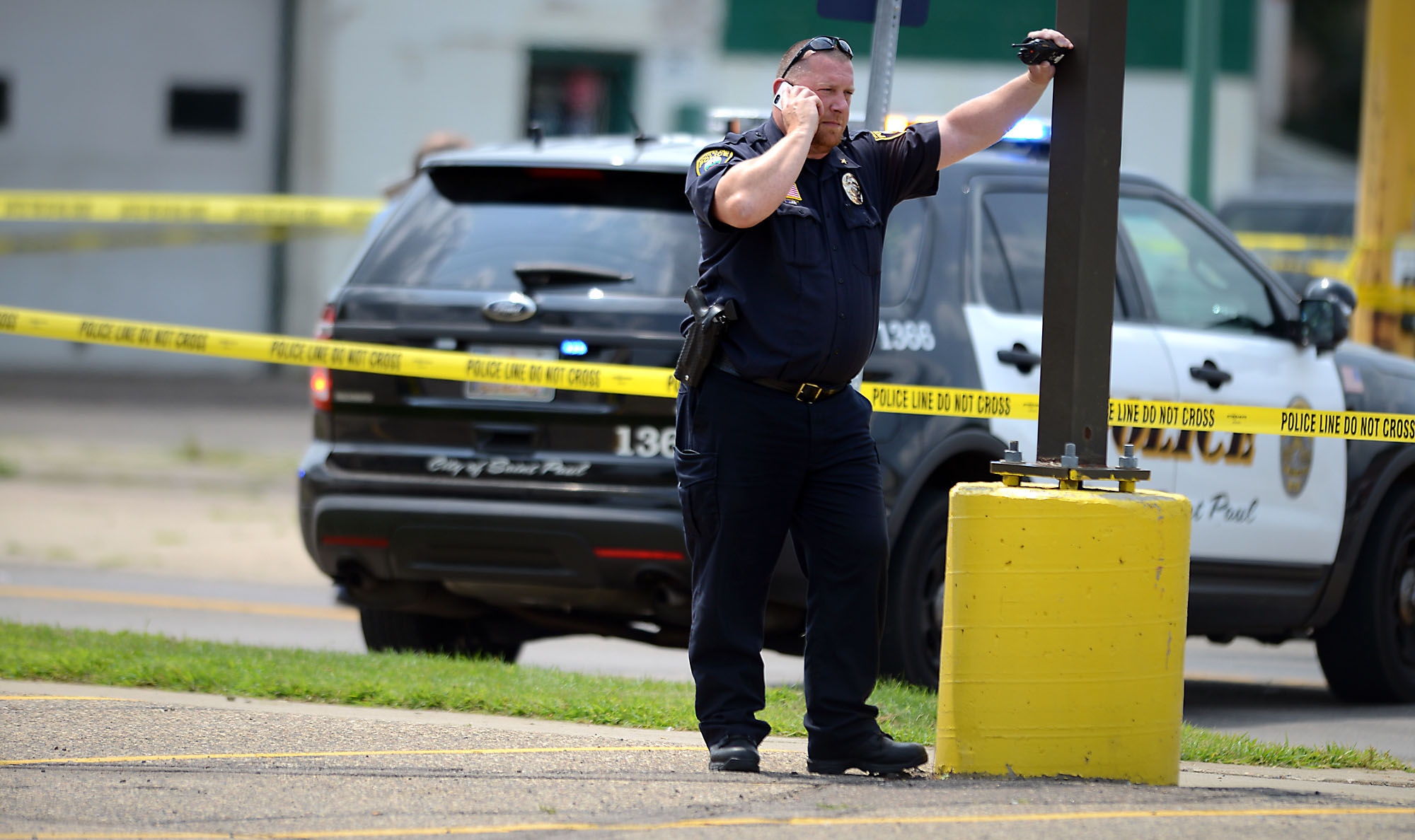 PHOTO: A law enforcement officer speaks on a phone near the site of a shooting in West St. Paul, Minn., July 30, 2014.