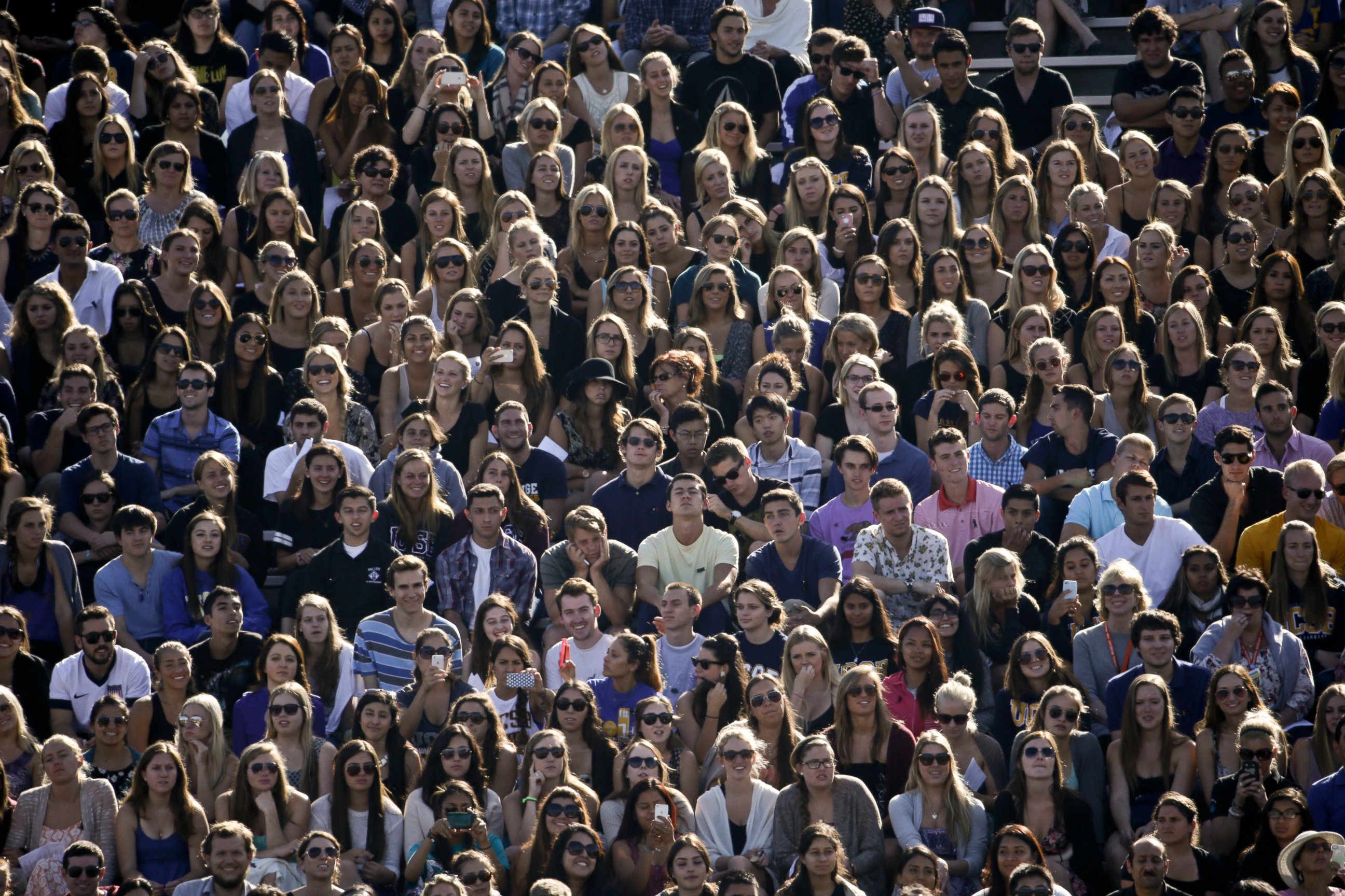 PHOTO: People listen to a memorial service at Harder Stadium on the campus of University of California, Santa Barbara, May 27, 2014.