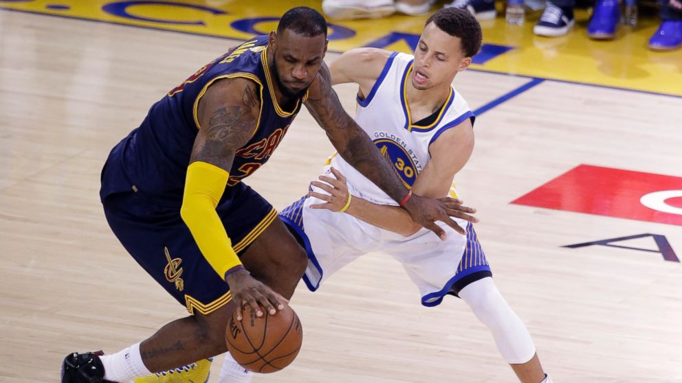 Cleveland Cavaliers forward LeBron James, left, is guarded by Golden State Warriors guard Stephen Curry during the second half of Game 2 of basketball's NBA Finals in Oakland, Calif., June 7, 2015.