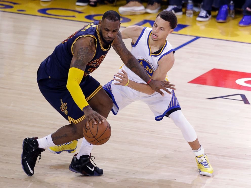 PHOTO: Cleveland Cavaliers forward LeBron James, left, is guarded by Golden State Warriors guard Stephen Curry during the second half of Game 2 of basketball's NBA Finals in Oakland, Calif., June 7, 2015.