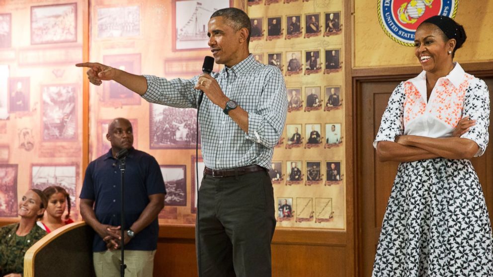 PHOTO: President Barack Obama, with first lady Michelle Obama, points toward a child in the audience as he greets troops and their families on Christmas Day, Dec. 25, 2014, at Marine Corps Base Hawaii in Kaneohe Bay, Hawaii.