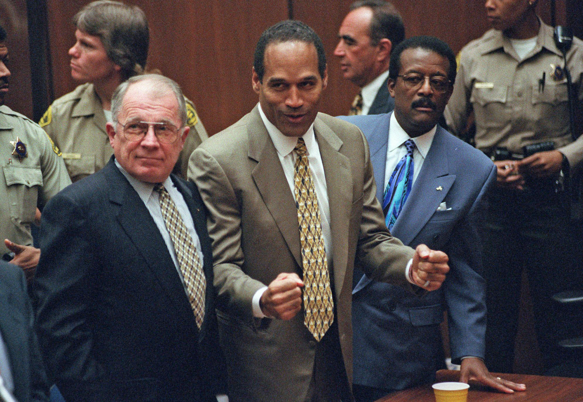 PHOTO: O.J. Simpson, center, reacts as he is found not guilty of murdering his ex-wife Nicole Brown and her friend Ron Goldman in court in Los Angeles, Oct. 3, 1995.