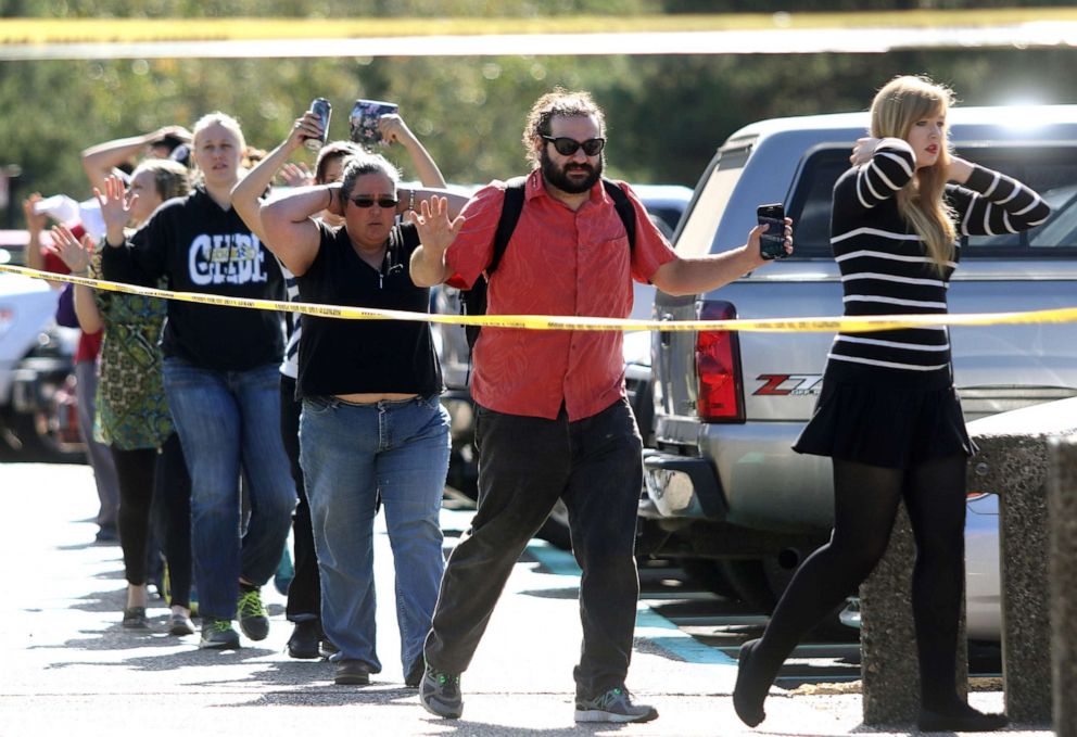  Students, staff and faculty are evacuated from Umpqua Community College in Roseburg, Ore. after a deadly shooting Thursday, Oct. 1, 2015.					