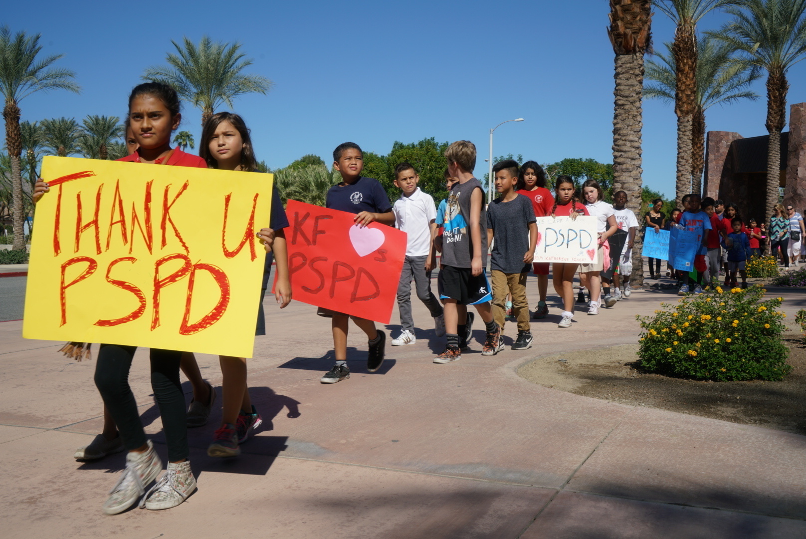 PHOTO: Fourth-graders from Katherine Finchy Elementary School walk outside the Palm Springs Convention Center, showing signs of support for the two fallen police officers, Gil Vega and Lesley Zerebny, on Oct. 18, 2016, in Palm Springs, California.