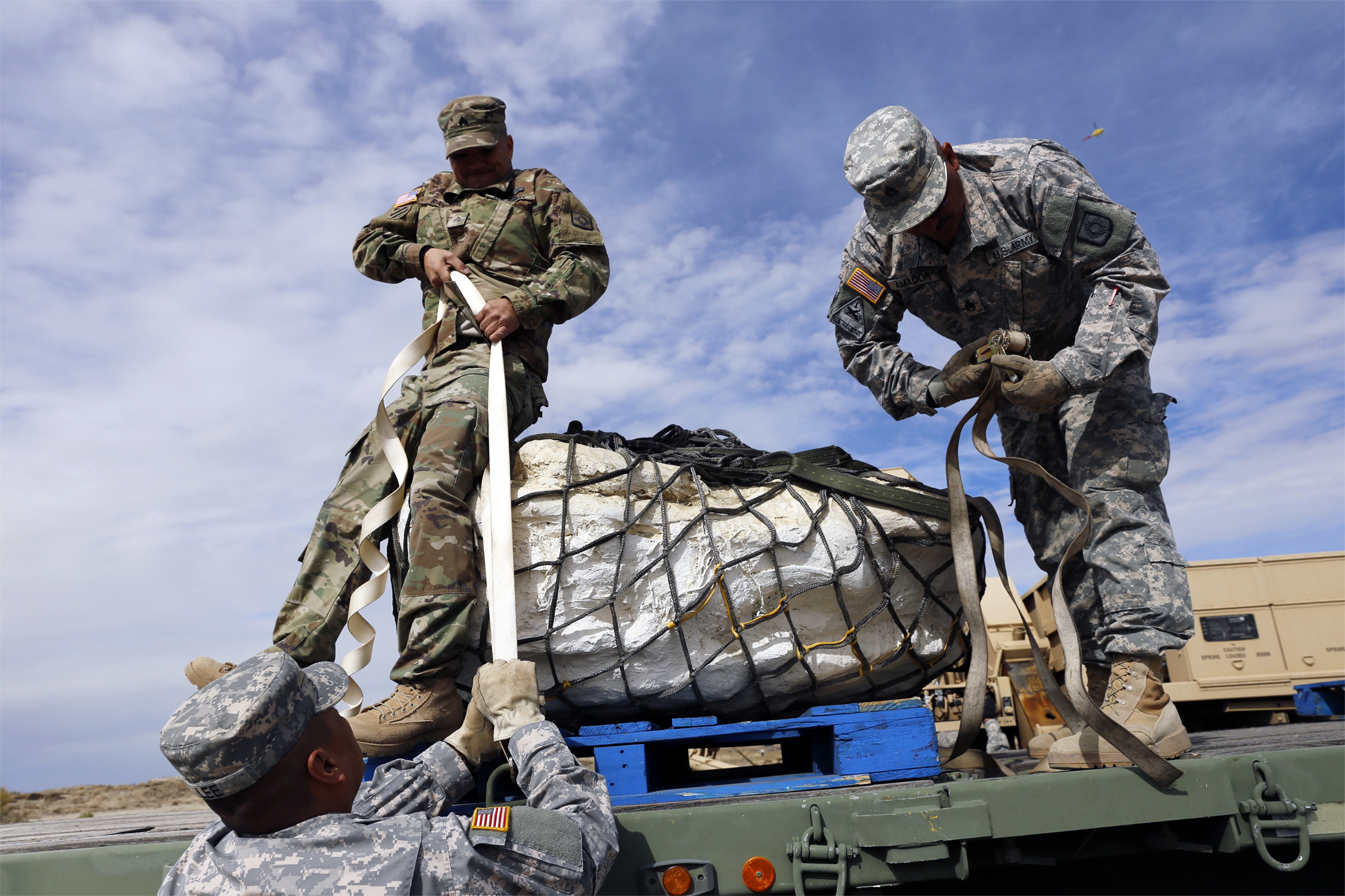 PHOTO:Sgt. 1st Class Terrill Lee, from left, Sgt. James Ray and Staff Sgt. Noe Amador, secure the remains of a Pentaceratops, Oct. 29, 2015, in the Bisti-De-Na-Zin Wilderness area south of Farmington, N.M.   