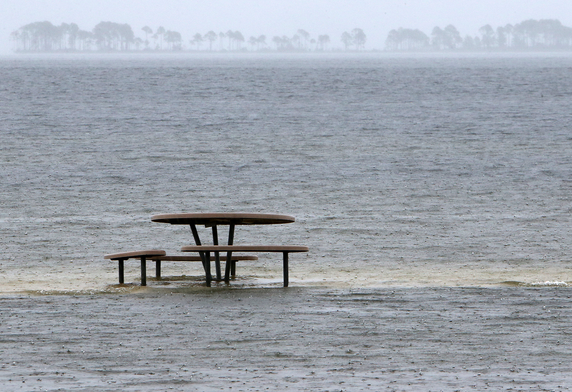 PHOTO: A picnic table is surrounded by rising water near Tyndall Air Force Base in Panama City, Florida, on June 6, 2016. 