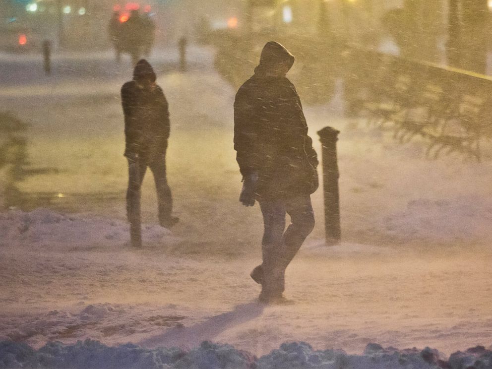 PHOTO: Pedestrians walk through wind-swept snow, Jan. 26, 2015, in Brooklyn, New York.