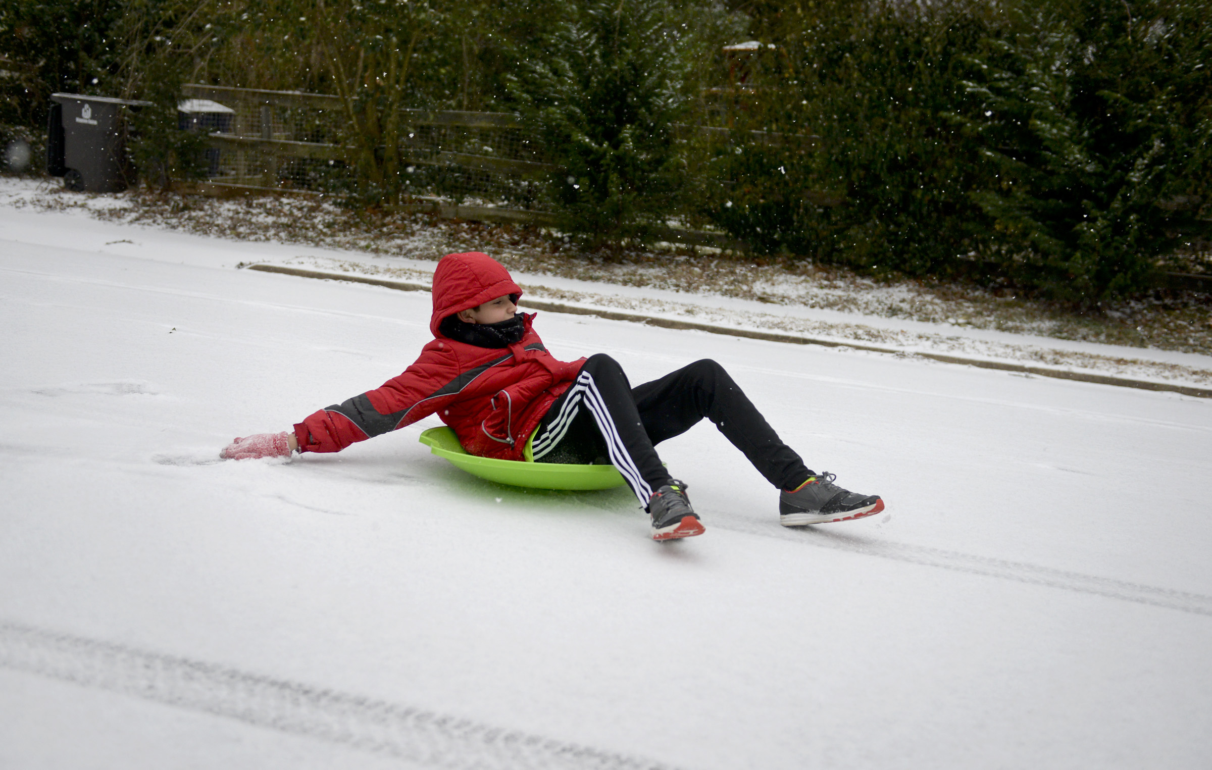 PHOTO: Pablo Hortal, 11, sleds down a street in Winston-Salem, N.C. as snow falls, Feb. 16, 2015.