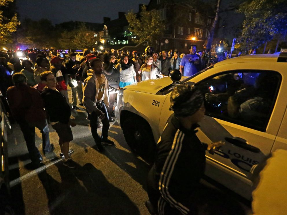 PHOTO: A crowd gathers Wednesday near the scene in south St. Louis where a man was fatally shot by an off-duty St. Louis police officer, Oct. 8, 2014.