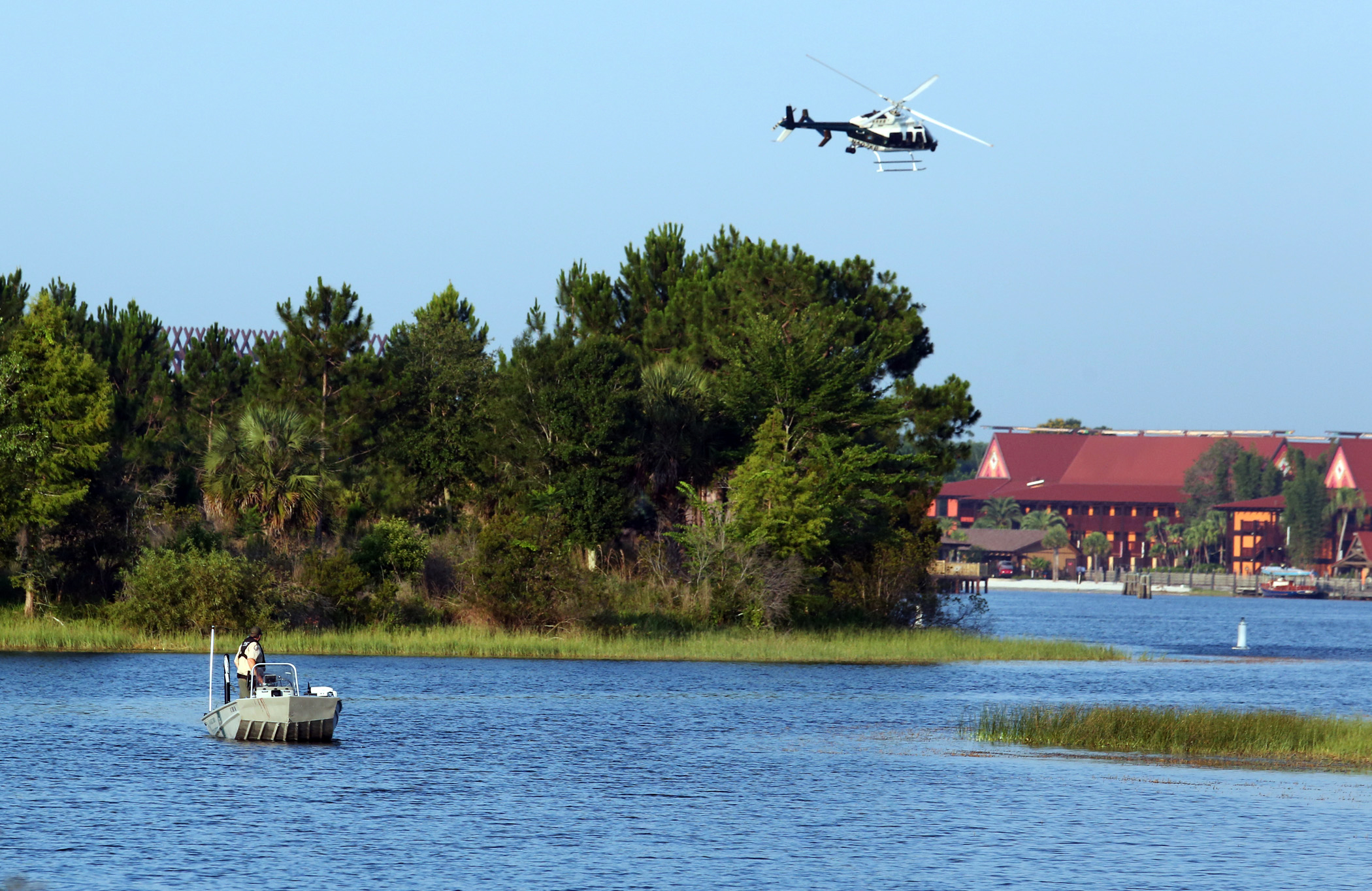 PHOTO: Fish and Wildlife and an Orange County Sheriffs helicopter search for a toddler June 15, 2016, after the boy was dragged into the water by an alligator near Disney's upscale Grand Floridian Resort & Spa in Lake Buena Vista, Florida. 