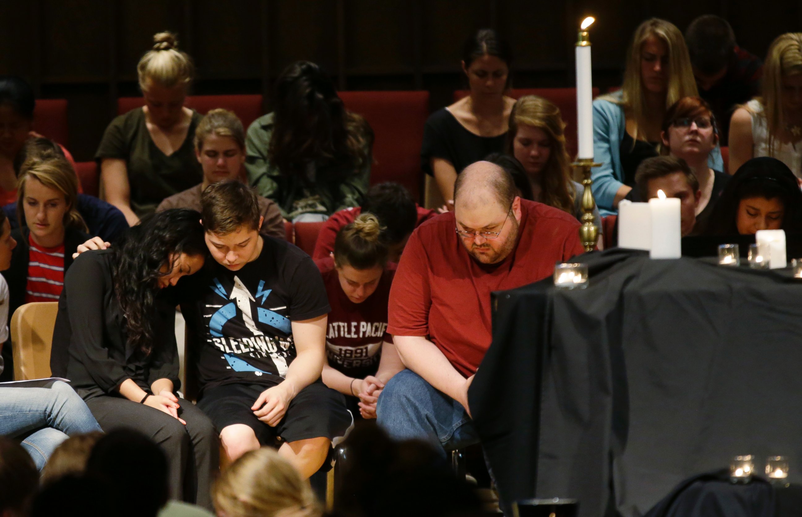 PHOTO: People bow their heads near a display of candles at a prayer service at First Free Methodist Church, June 5, 2014, on the campus of Seattle Pacific University in Seattle.