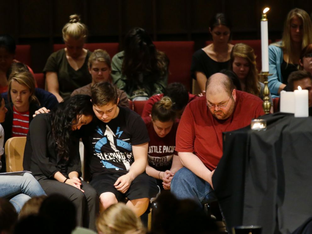 PHOTO: People bow their heads near a display of candles at a prayer service at First Free Methodist Church, June 5, 2014, on the campus of Seattle Pacific University in Seattle.