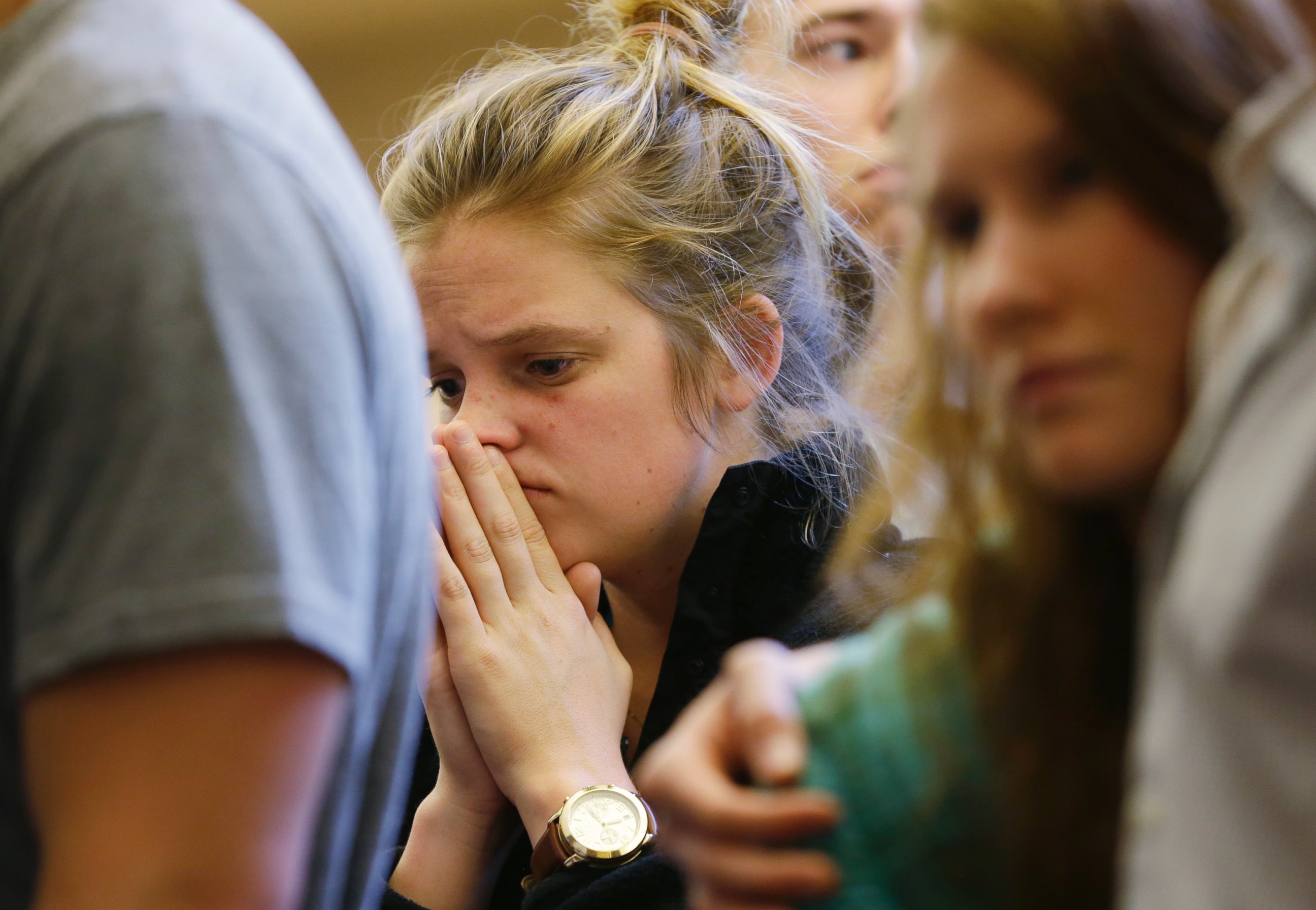 PHOTO: A woman prays at a service at the First Free Methodist Church, June 5, 2014, following a shooting at Seattle Pacific University.