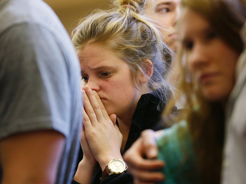PHOTO: A woman prays at a service at the First Free Methodist Church, June 5, 2014, following a shooting at Seattle Pacific University.