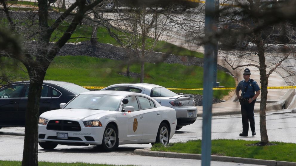A Kansas State Trooper stands near the location of a shooting at the Jewish Community Center in Overland Park, Kan., April 13, 2014.