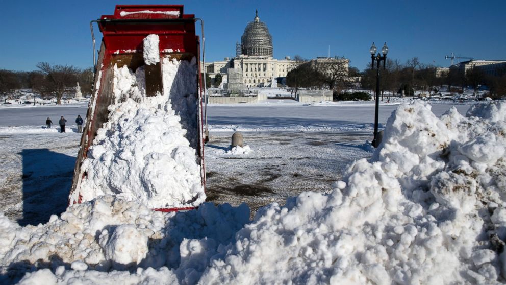 PHOTO:A dump truck empties a load of snow in front of the U.S. Capitol Building in Washington, Jan. 24, 2016. 