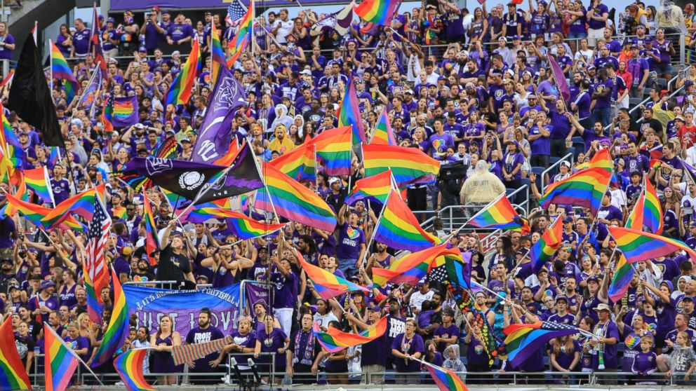 PHOTO: Some of the fans for the Orlando City SC wave rainbow flags before the start of an MLS match between Orlando City and the San Jose Earthquakes at Camping World Stadium in Orlando, June 18, 2016.