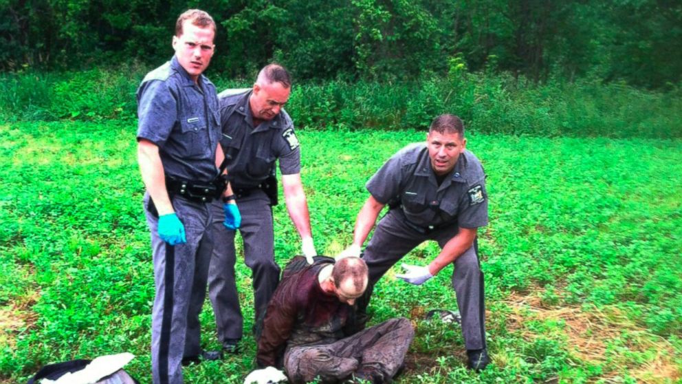 PHOTO: Police stand over David Sweat after he was shot and captured near the Canadian border, June 28, 2015, in Constable, N.Y. 