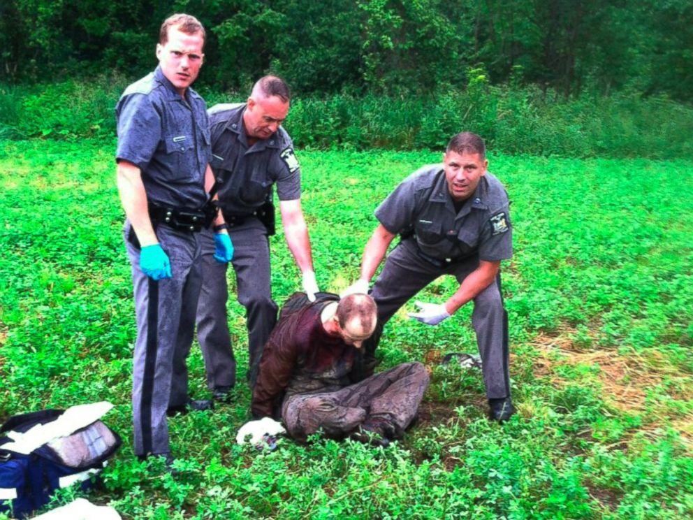 PHOTO: Police stand over David Sweat after he was shot and captured near the Canadian border, June 28, 2015, in Constable, N.Y.