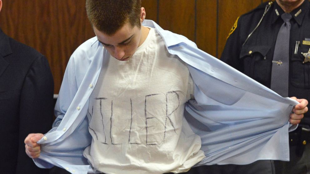 In this Tuesday, March 19, 2013, photo, T.J. Lane unbuttons his shirt during sentencing in Chardon, Ohio. Ohio police said Thursday, Sept. 11, 2014, that Lane, 19, the convicted killer of three students at a high school cafeteria, escaped from prison.