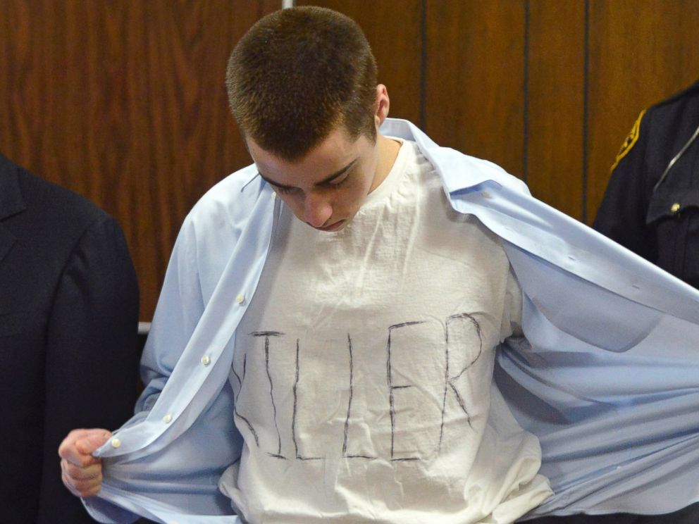 In this Tuesday, March 19, 2013, photo, T.J. Lane unbuttons his shirt during sentencing in Chardon, Ohio. Ohio police said Thursday, Sept. 11, 2014, that Lane, 19, the convicted killer of three students at a high school cafeteria, escaped from prison.