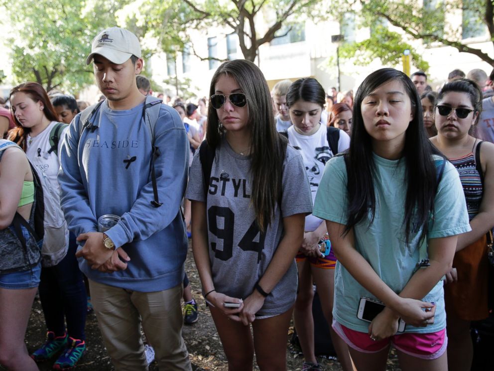 PHOTO: University of Texas students take part in a moment of silence during a gathering for fellow student Haruka Weiser on campus April 7, 2016, in Austin, Texas.