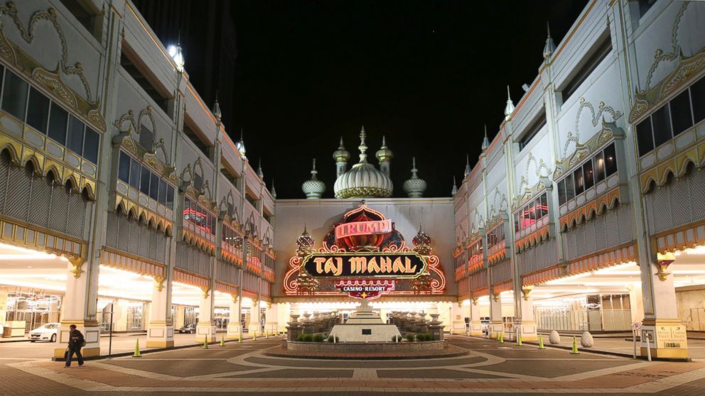 PHOTO: A person walks from the Trump Taj Mahal early on Oct. 10, 2016, in Atlantic City, New Jersey. The casino shut down at 5:59 a.m., Oct. 10, 2016.