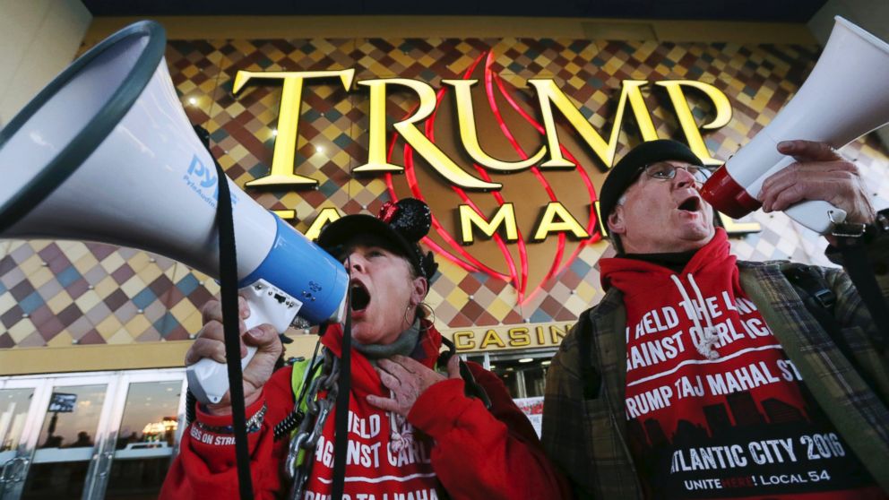 PHOTO: Members of Local 54 of the Unite-HERE union, Tina Condos, a cocktail waitress at Trump Taj Mahal and Keith Fullmer, a bartender, shout early in the morning outside the closing Trump Taj Mahal on Oct. 10, 2016, in Atlantic City, New Jersey.