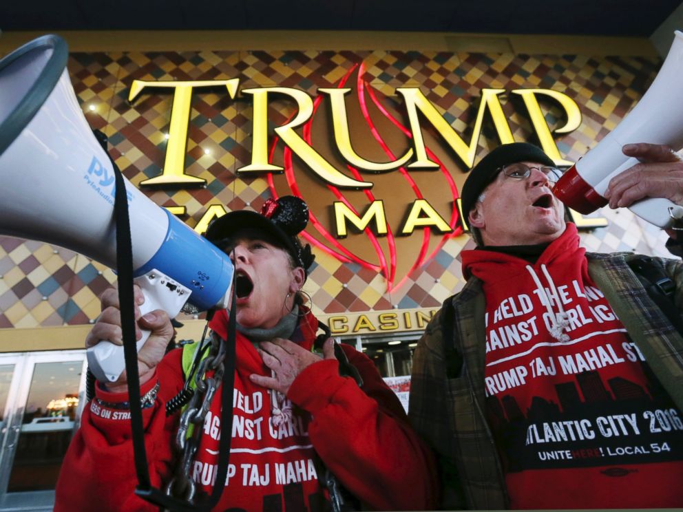 PHOTO: Members of Local 54 of the Unite-HERE union, Tina Condos, a cocktail waitress at Trump Taj Mahal and Keith Fullmer, a bartender, shout early in the morning outside the closing Trump Taj Mahal on Oct. 10, 2016, in Atlantic City, New Jersey.