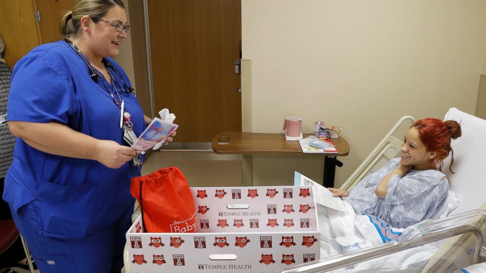 PHOTO: Registered nurse Christine Weick discuses with mother Keyshla Rivera the contents of a baby box before her discharge from Temple University Hospital in Philadelphia, May 6, 2016. 