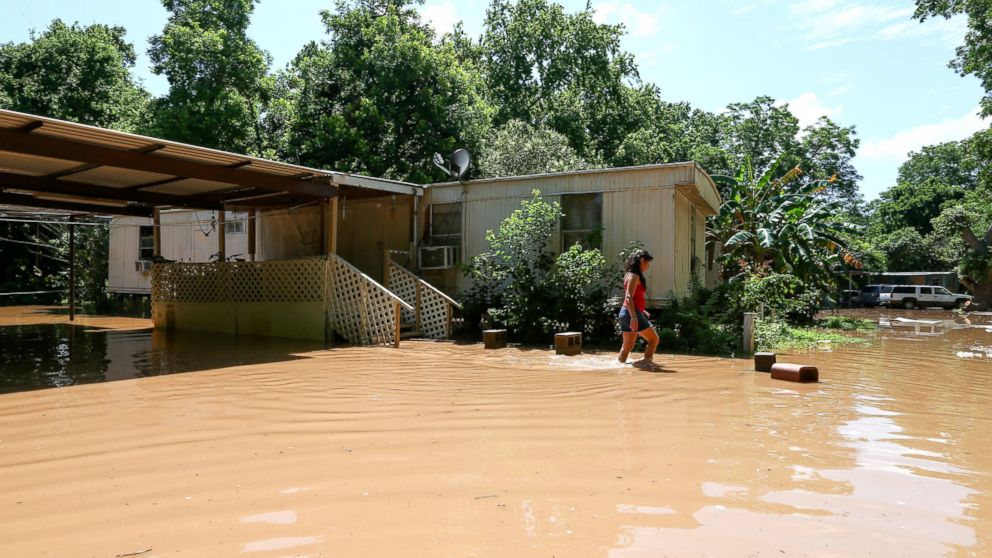 PHOTO:Irene Martinez, who lives near the Brazos River, leaves her flooded home, May 29, 2016, in Richmond, Texas.   