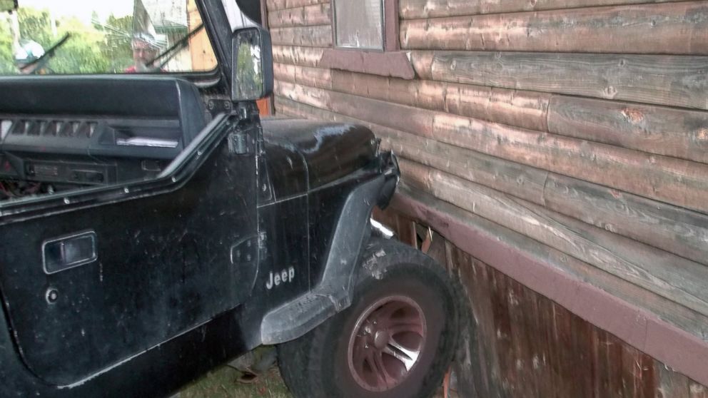 Authorities say a toddler crashed this Jeep into a home in Myrtle Creek, Ore. after knocking the vehicle out of gear, July 24, 2014.