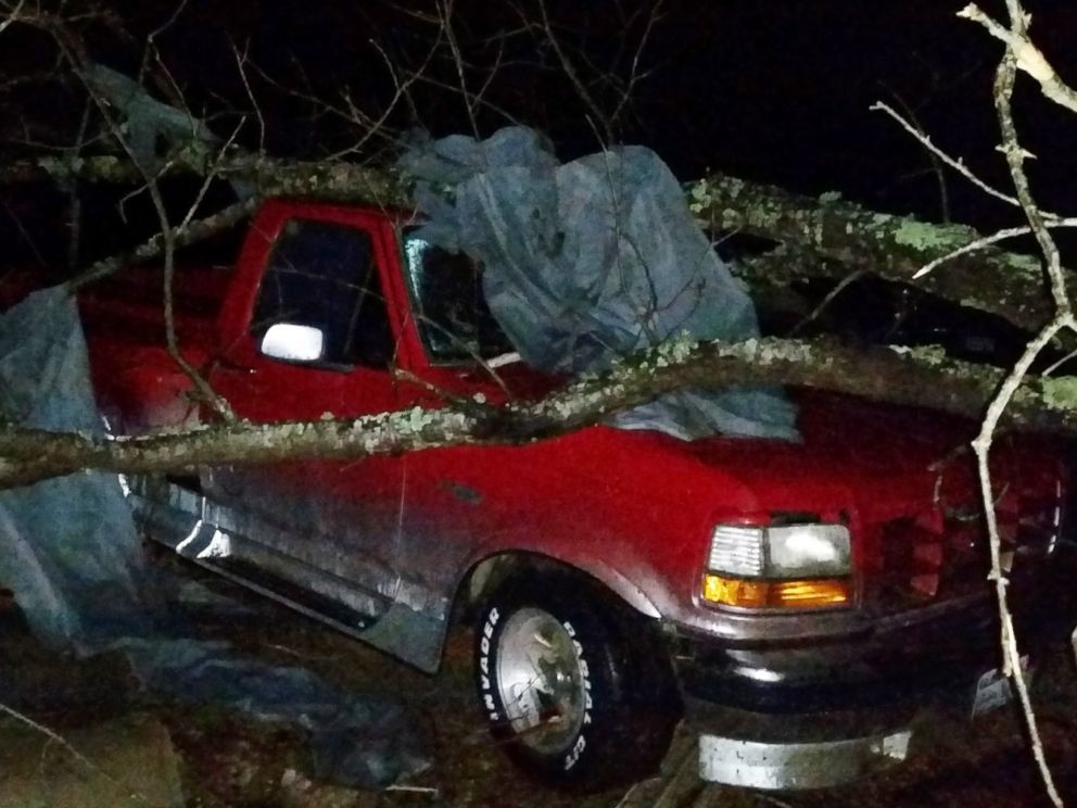 PHOTO: A fallen tree rests atop a pickup truck in Holly Springs, Miss., after a storm struck the town on Dec. 23, 2015.
