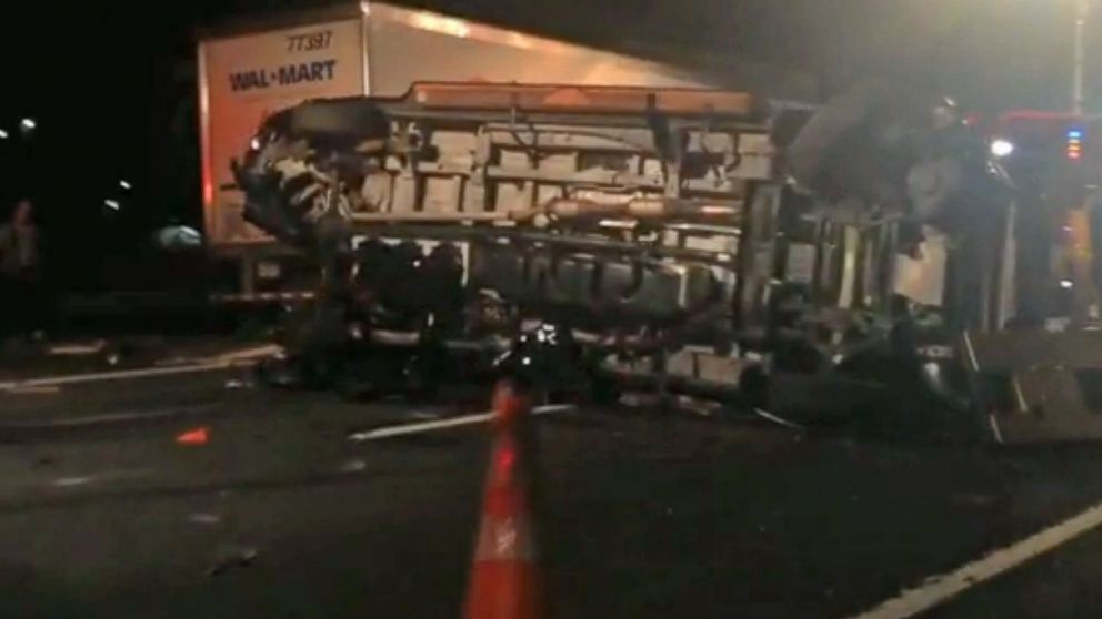 In this image from video the limousine bus carrying Tracy Morgan and six other people lies on it's side early Saturday morning June 7, 2014 on the New Jersey Turnpike. Morgan remained hospitalized as state and federal officials continued their investigation of the six-vehicle crash on the New Jersey Turnpike that took the life of a Morgan friend and left two others seriously injured, authorities say.