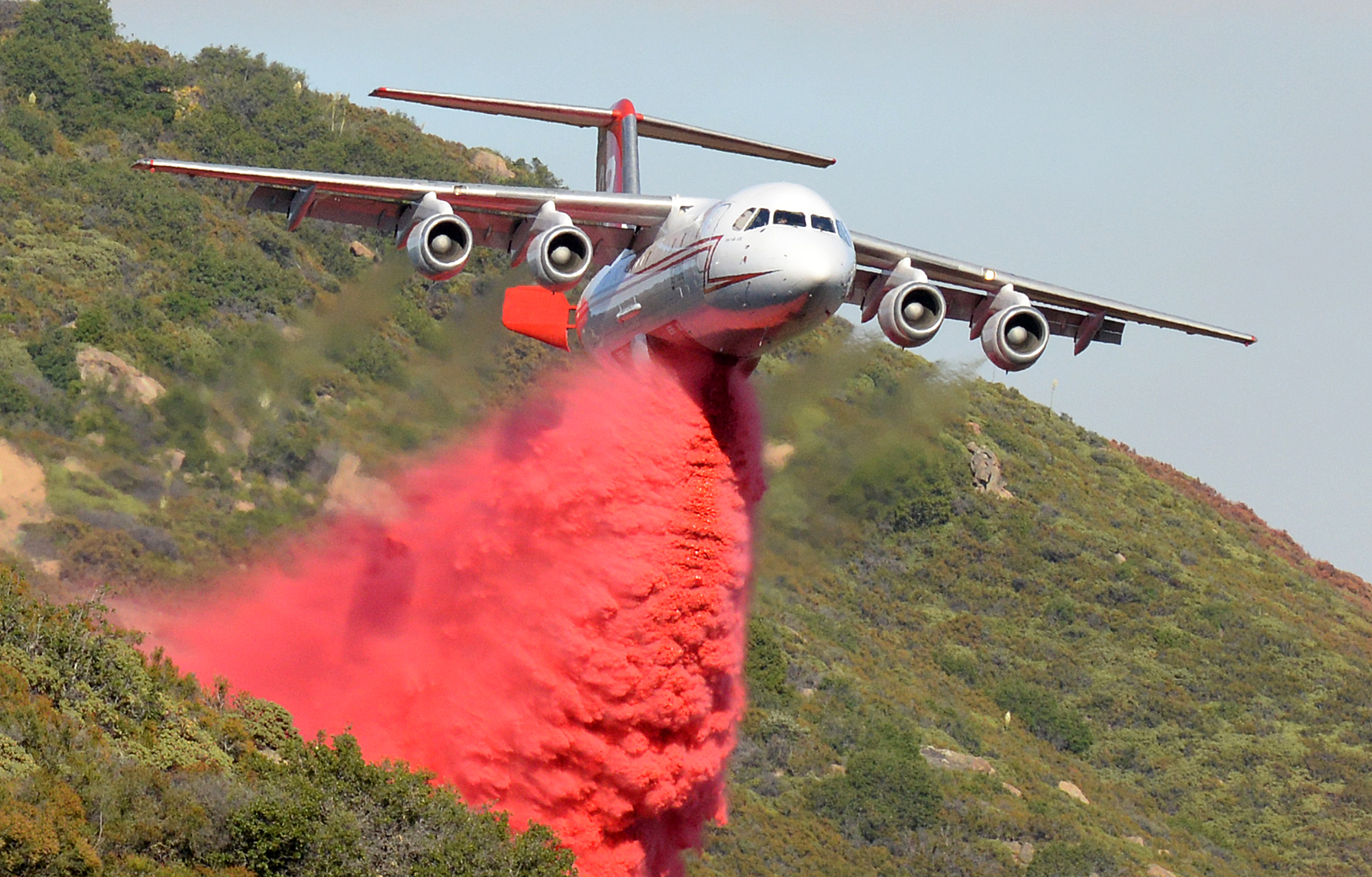 PHOTO: A British Aerospace BAe-146 belonging to Neptune Aviation makes a Phos-Chek drop, June 18, 2016, on wildfires in Santa Barbara County, Calif.