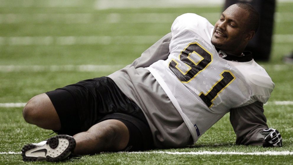 PHOTO: New Orleans Saints defensive end Will Smith stretches during practice at their NFL football training facility in Metairie, La.,Sept. 21, 2011. 