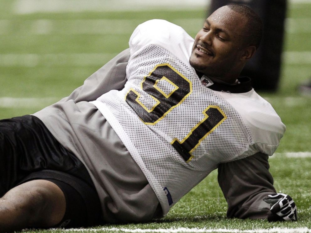 PHOTO: New Orleans Saints defensive end Will Smith stretches during practice at their NFL football training facility in Metairie, La.,Sept. 21, 2011.