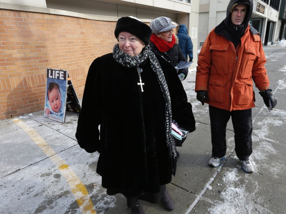 PHOTO: An anti-abortion protester stands at the painted edge of a buffer zone outside a Planned Parenthood location in Boston, Dec. 17, 2013.